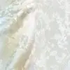 Elegant white floral tone-on-tone tablecloth.