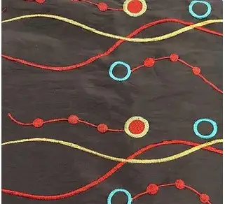 Black, yellow, red, and green taffeta wave and circle print tablecloth and runner.