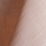 Blush pink textured dinner napkin.