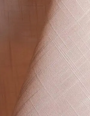 Blush pink textured dinner napkin.