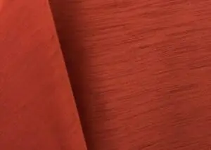 Burnt orange majestic dupioni tablecloth, runner, sash, and dinner napkin.
