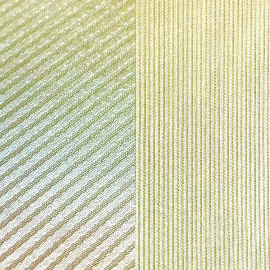 Cream striped tablecloth, dinner napkin, and cocktail napkin.