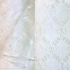 White sheer embroidered tablecloth and runner.