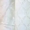 White sheer embroidered tablecloth and runner.