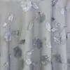 Sheer grey dimensional floral print tablecloth.