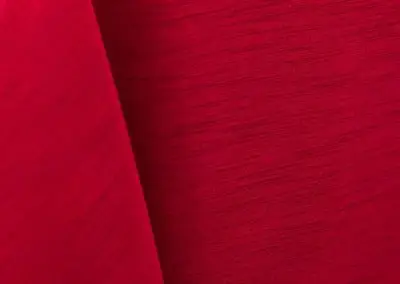 Bright red majestic dupioni tablecloth, runner, sash, and dinner napkin.