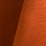 Orange polyester tablecloth, runner, sash, and dinner napkin.