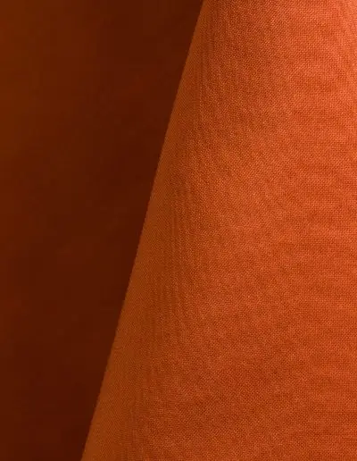 Orange polyester tablecloth, runner, sash, and dinner napkin.