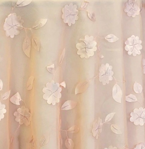 Peach dimensional floral print tablecloth.