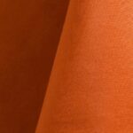 Bright orange polyester tablecloth, runner, sash, and dinner napkin.