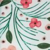 Peach, coral, and green floral print polyester dinner napkin on a white background.